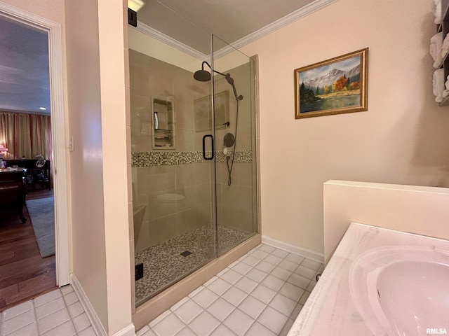 bathroom featuring tile patterned floors, a shower with shower door, and crown molding