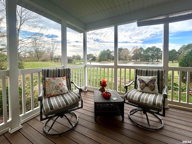 sunroom featuring a water view and a wealth of natural light