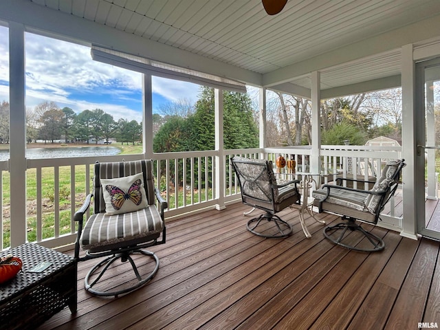 sunroom featuring a healthy amount of sunlight and a water view