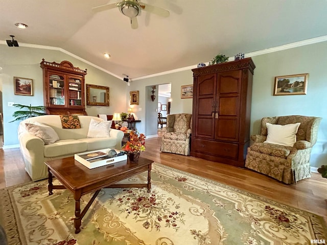 living room featuring light hardwood / wood-style floors, crown molding, and vaulted ceiling