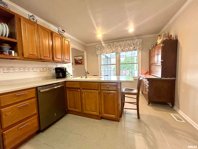 kitchen featuring dishwasher, sink, ornamental molding, kitchen peninsula, and a breakfast bar area