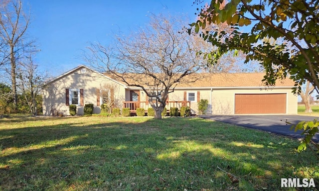 ranch-style home featuring a garage and a front lawn