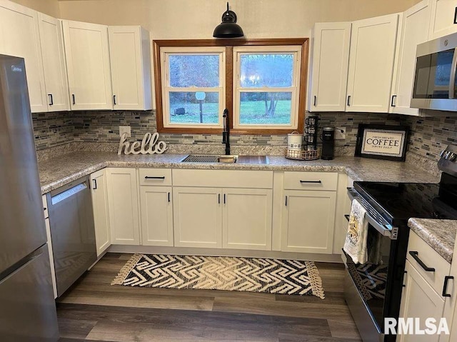 kitchen featuring white cabinets, appliances with stainless steel finishes, dark hardwood / wood-style flooring, and sink