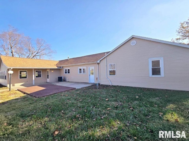 rear view of house with a lawn, a patio area, and central AC