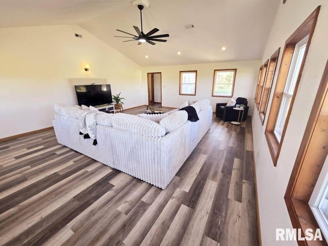 living room with ceiling fan, lofted ceiling, and dark wood-type flooring