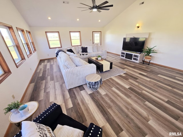 living room with hardwood / wood-style flooring, vaulted ceiling, and ceiling fan