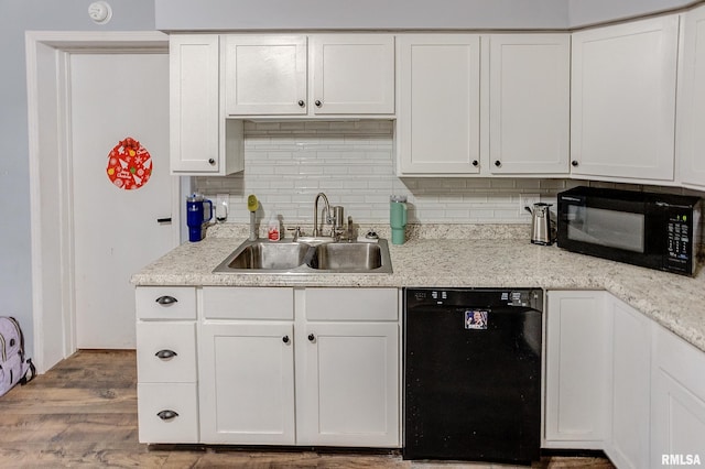 kitchen with black appliances, white cabinets, wood-type flooring, and sink