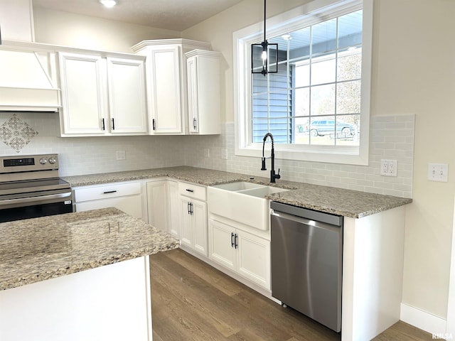 kitchen with white cabinets, wood-type flooring, sink, and appliances with stainless steel finishes