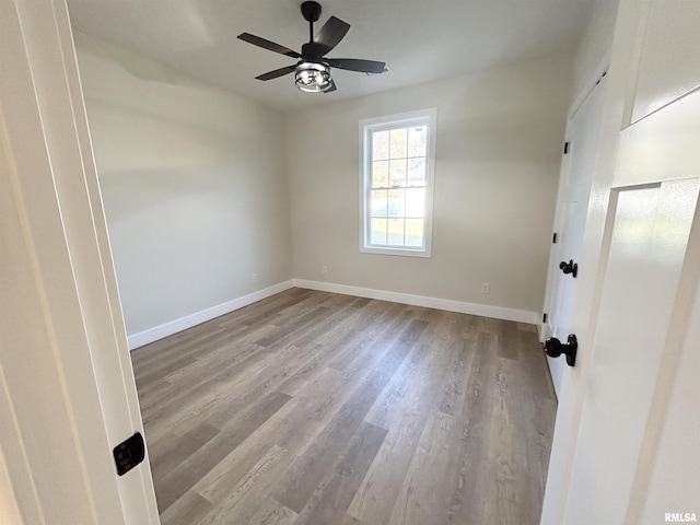 spare room with light hardwood / wood-style floors and ceiling fan