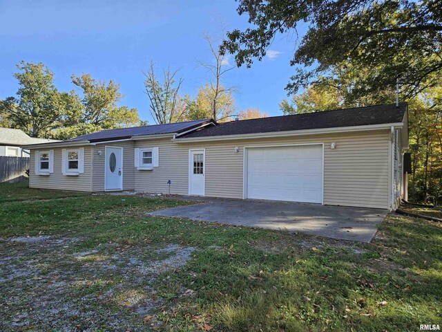 view of front of home with a garage and a front lawn