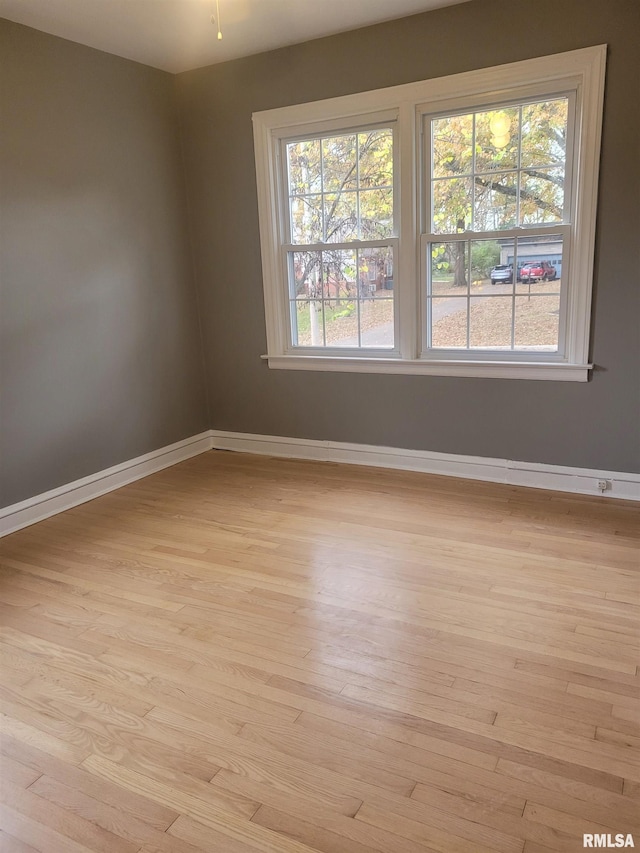 unfurnished room with light hardwood / wood-style flooring