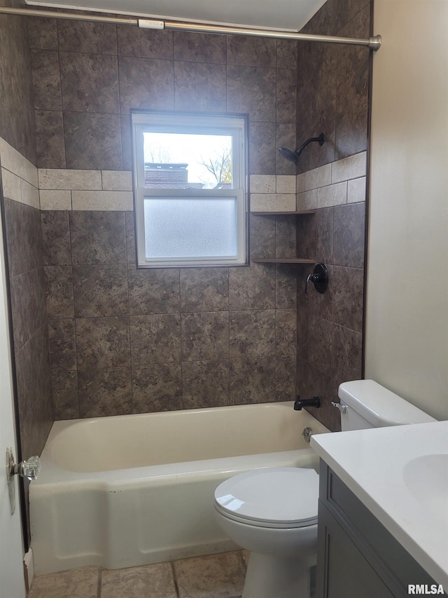 full bathroom with tile patterned flooring, vanity, toilet, and tiled shower / bath