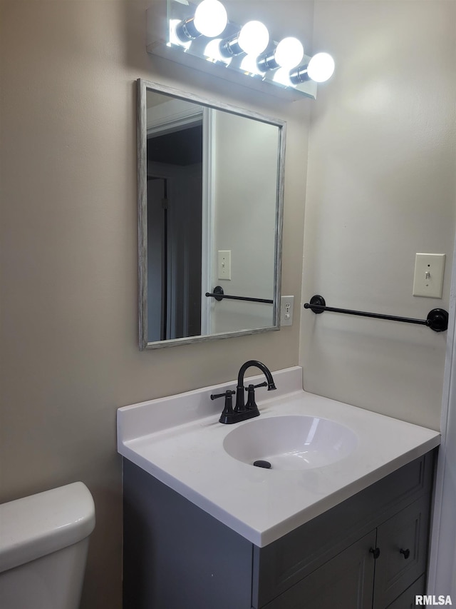 bathroom featuring vanity and toilet