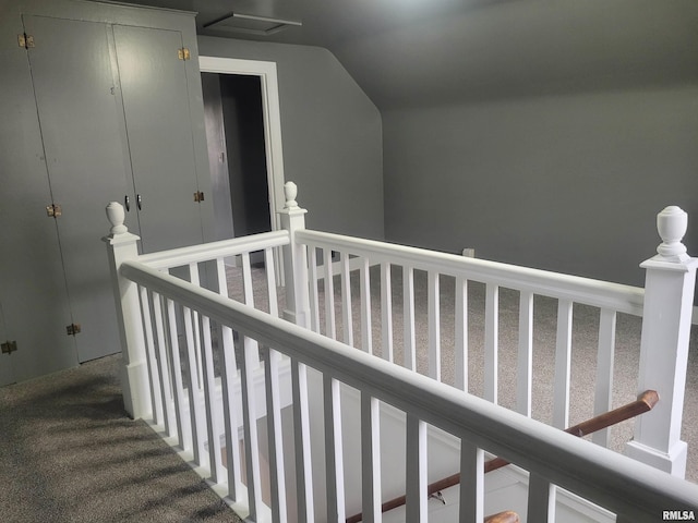 hallway with carpet and lofted ceiling