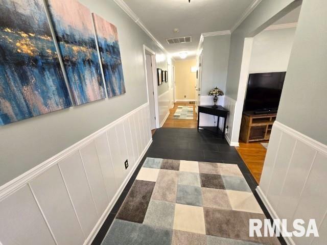 hallway featuring dark hardwood / wood-style flooring and ornamental molding