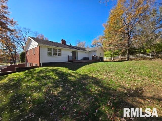 rear view of house with a lawn