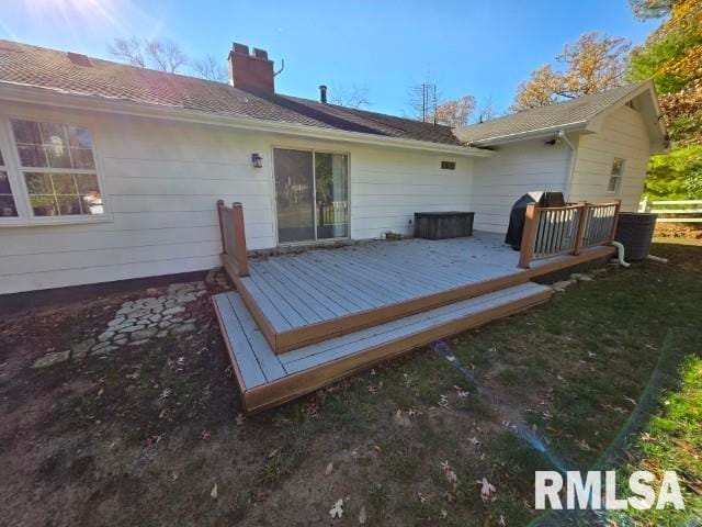 rear view of house featuring a wooden deck