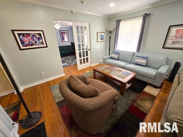 living room with french doors, hardwood / wood-style flooring, and ornamental molding