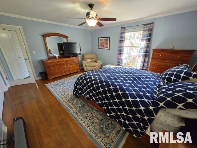 bedroom with ceiling fan, dark hardwood / wood-style flooring, and ornamental molding