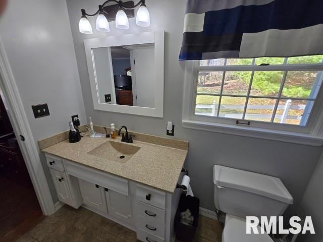 bathroom featuring vanity and toilet