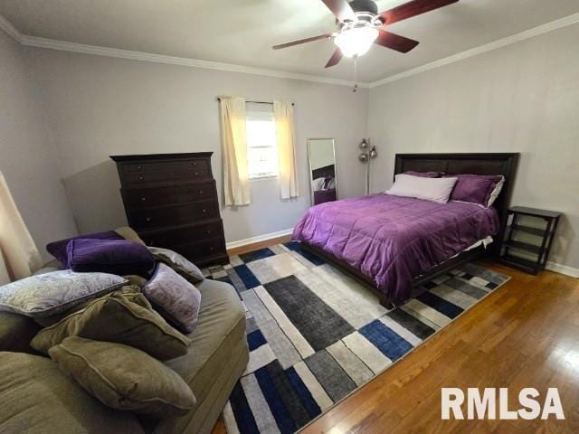 bedroom featuring ceiling fan, dark hardwood / wood-style flooring, and crown molding