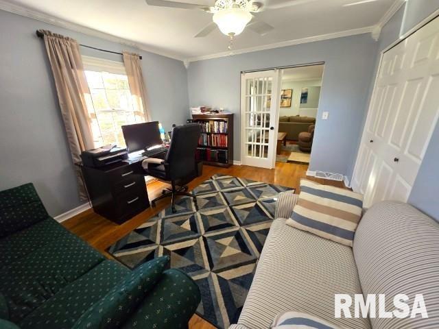 office space featuring ceiling fan, wood-type flooring, crown molding, and french doors