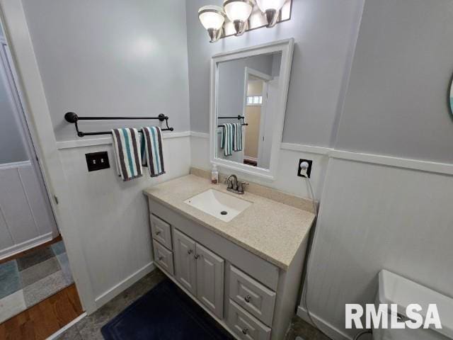 bathroom with vanity, wood-type flooring, and toilet