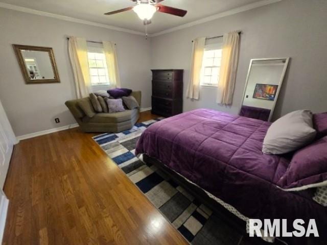 bedroom featuring hardwood / wood-style flooring, multiple windows, ornamental molding, and ceiling fan