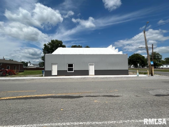 view of side of home featuring an outbuilding