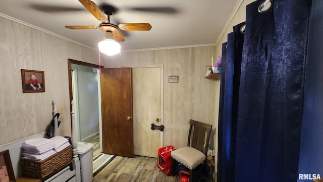 interior space featuring a closet, light hardwood / wood-style floors, ceiling fan, and ornamental molding