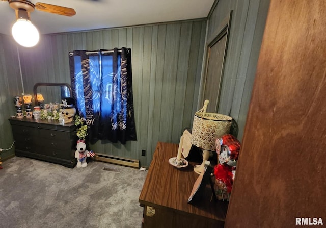 bedroom featuring carpet floors, ceiling fan, and a baseboard heating unit