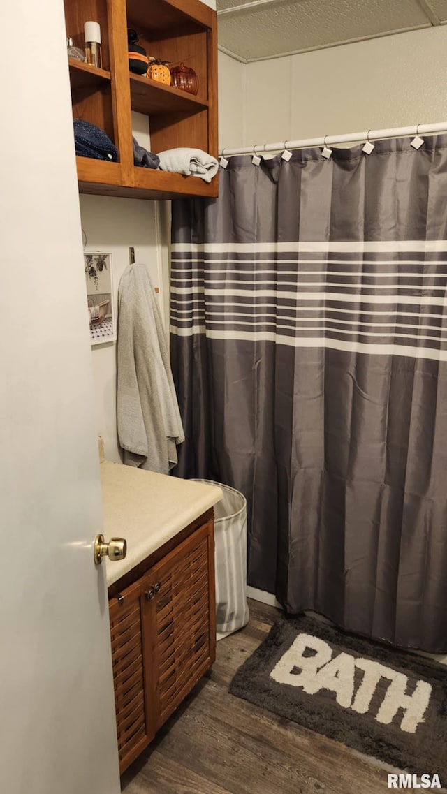 bathroom featuring wood-type flooring, vanity, and a textured ceiling