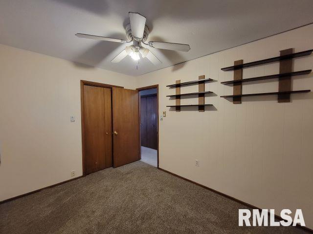 unfurnished bedroom with carpet floors, a closet, and ceiling fan