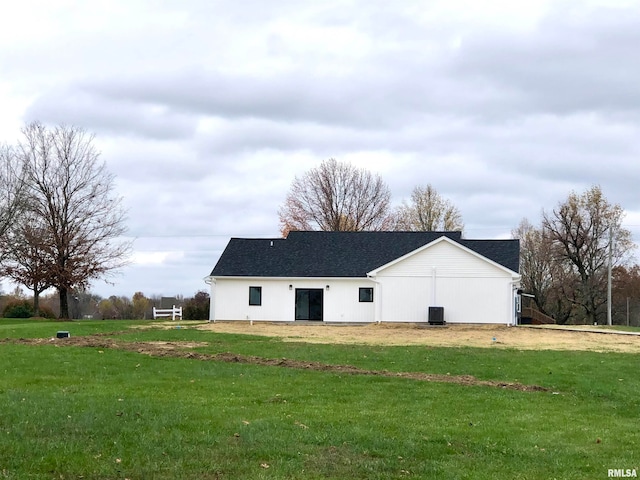 rear view of property with a yard