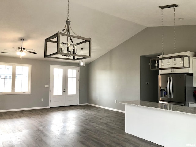 kitchen with stainless steel fridge, dark hardwood / wood-style flooring, ceiling fan, hanging light fixtures, and lofted ceiling