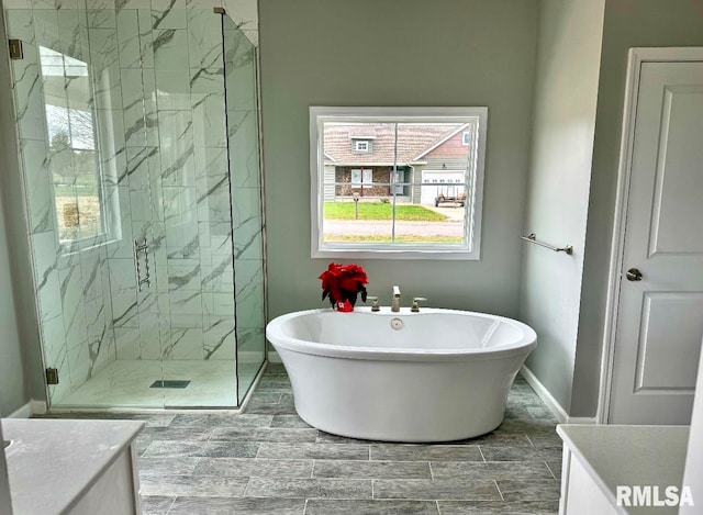 bathroom with vanity and independent shower and bath