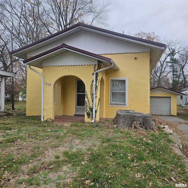 view of front facade featuring a garage and an outdoor structure