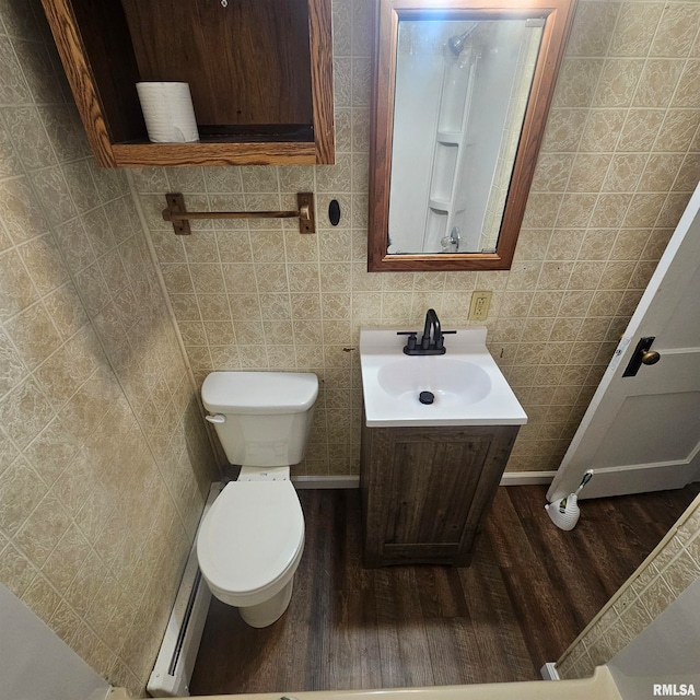 bathroom featuring vanity, hardwood / wood-style flooring, and tile walls