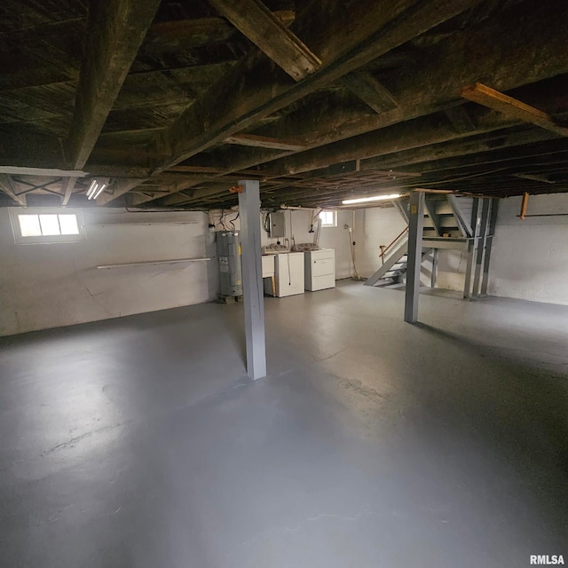 basement with washing machine and dryer and electric water heater