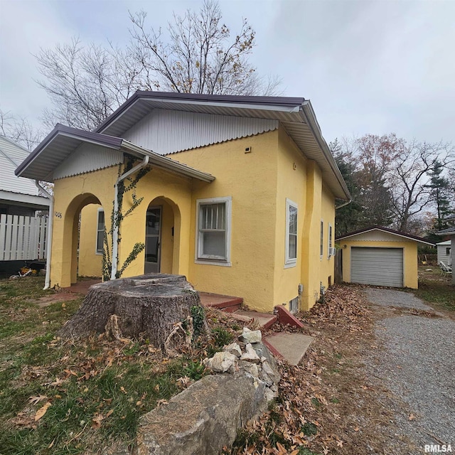 view of front of home with a garage and an outdoor structure