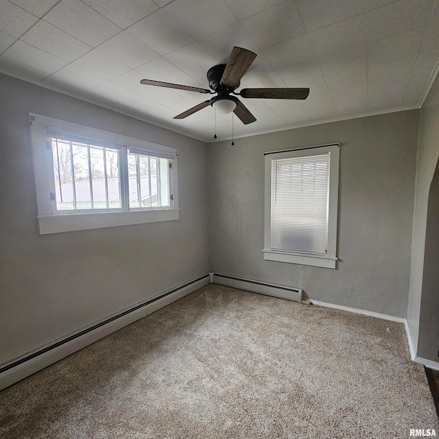 unfurnished room with a baseboard heating unit, carpet floors, ceiling fan, and crown molding