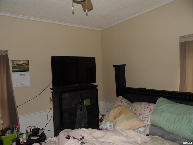 bedroom featuring ceiling fan and ornamental molding