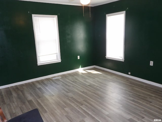 805 Samuel St, Christopher, IL 62822 - spare room with healthy amount of natural light, wood finished floors, baseboards, ceiling fan, and ornamental molding