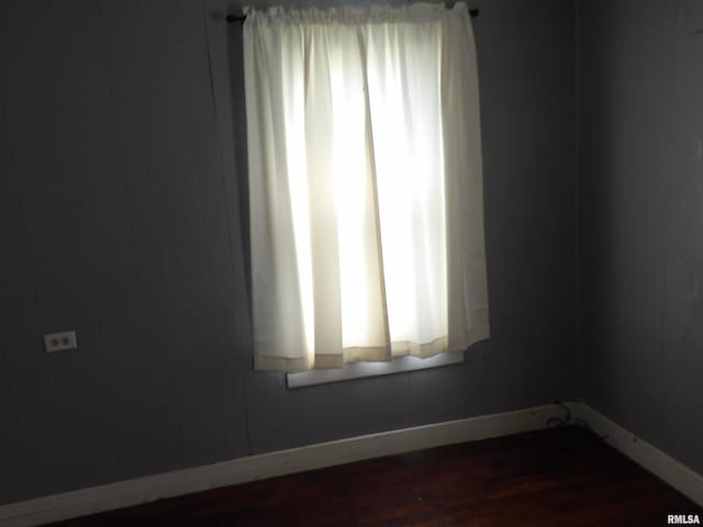 805 Samuel St, Christopher, IL 62822 - spare room featuring baseboards and dark wood-type flooring