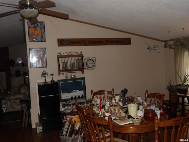 dining room featuring lofted ceiling, ceiling fan, a textured ceiling, and hardwood / wood-style flooring