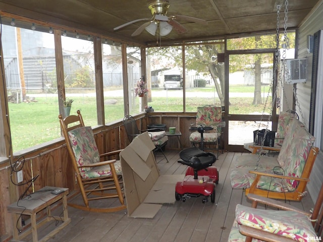 sunroom with an AC wall unit and ceiling fan