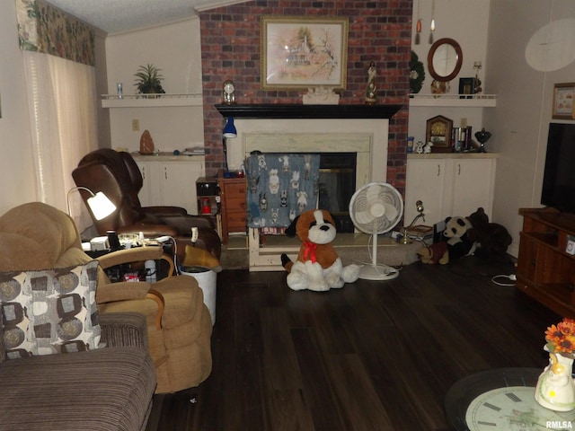 living room with dark hardwood / wood-style flooring, lofted ceiling, and a textured ceiling