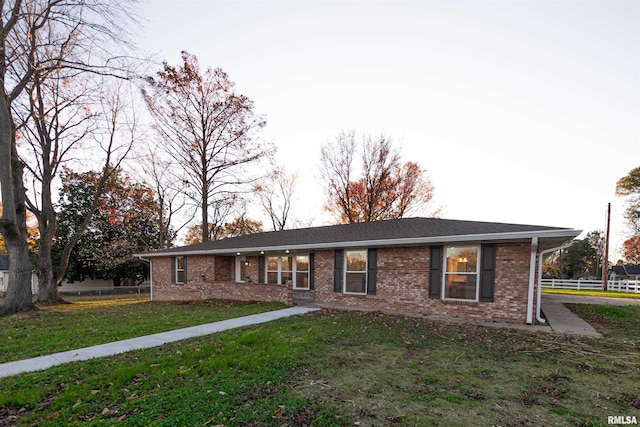 ranch-style home with a front lawn