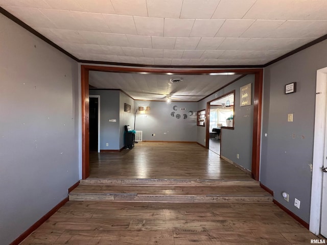 corridor with hardwood / wood-style floors and crown molding