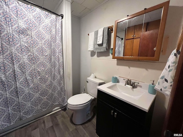 bathroom featuring a shower with curtain, toilet, vanity, and hardwood / wood-style flooring